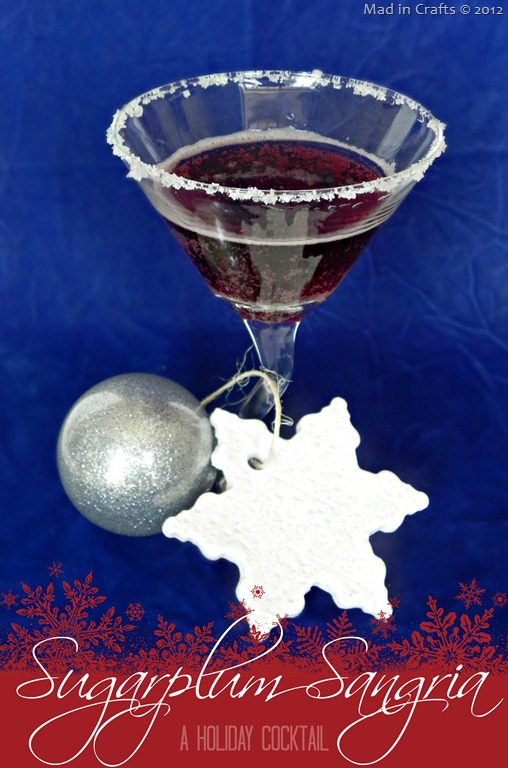 Sangria cocktail in a martini glass with Christmas ornaments
