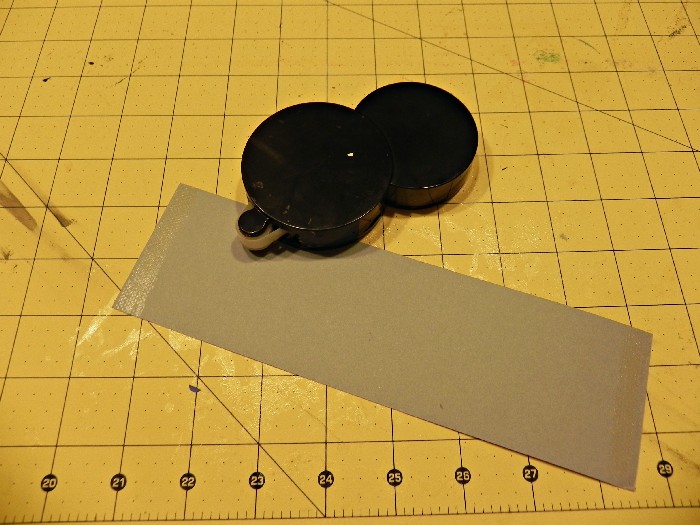 roll-adhesive-onto-silver-paper