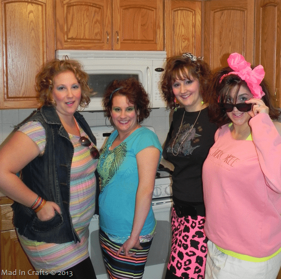 4 women wearing 80s costumes