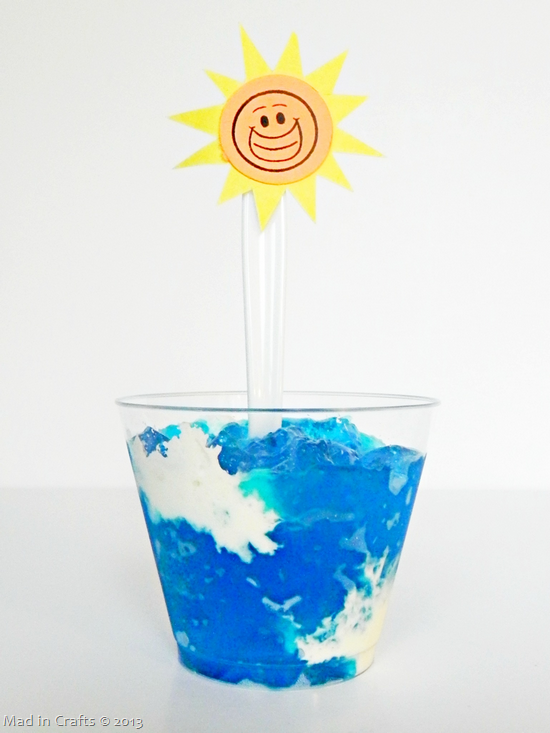 summer sky jello snack in a plastic cup with a spoon decorated with a paper sun