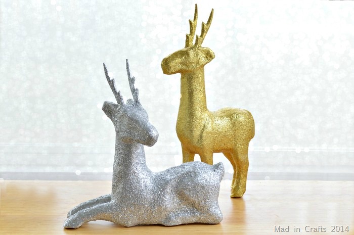DIY glittery paper mache deer in front of a bokeh background