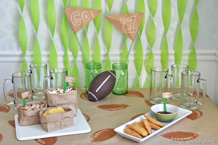 Super Bowl Decor including streamer, a stamped table cover and snacks