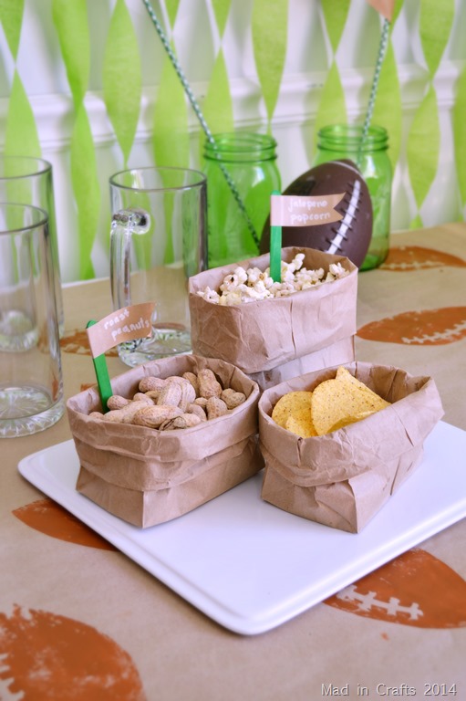 3 paper bag bowls containing football party snacks