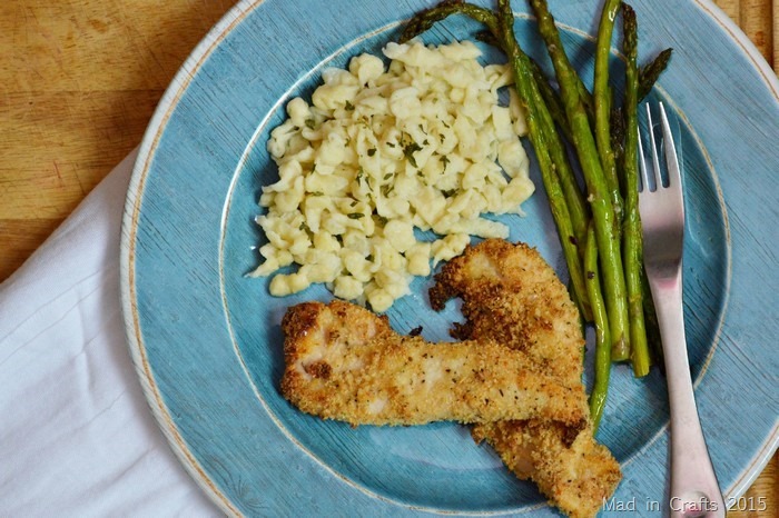 Blue plate of breaded chicken, spaetzle, and asparagus