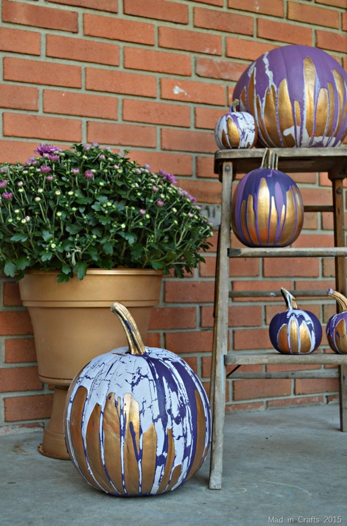 fall porch display of painted pumpkins and fall mums