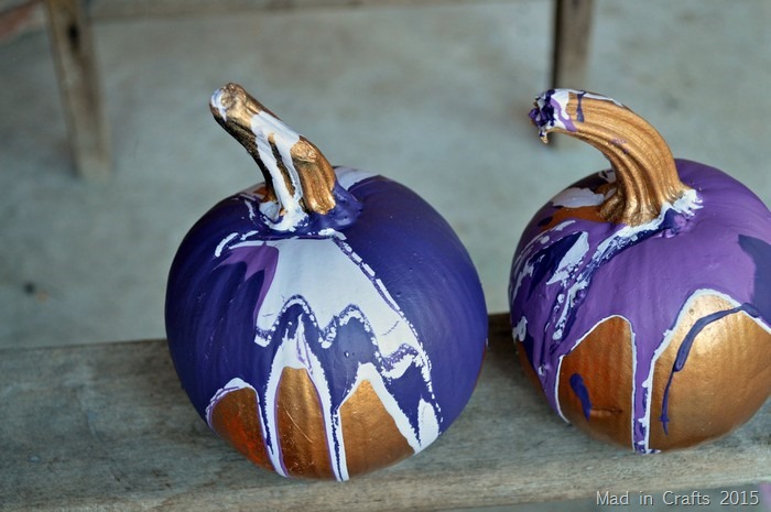 two small purple paint pour pumpkins