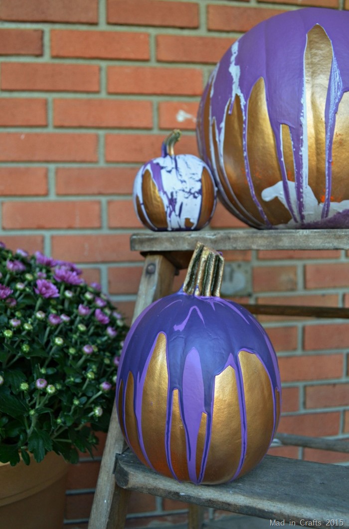 paint pour pumpkins on a wooden step ladder