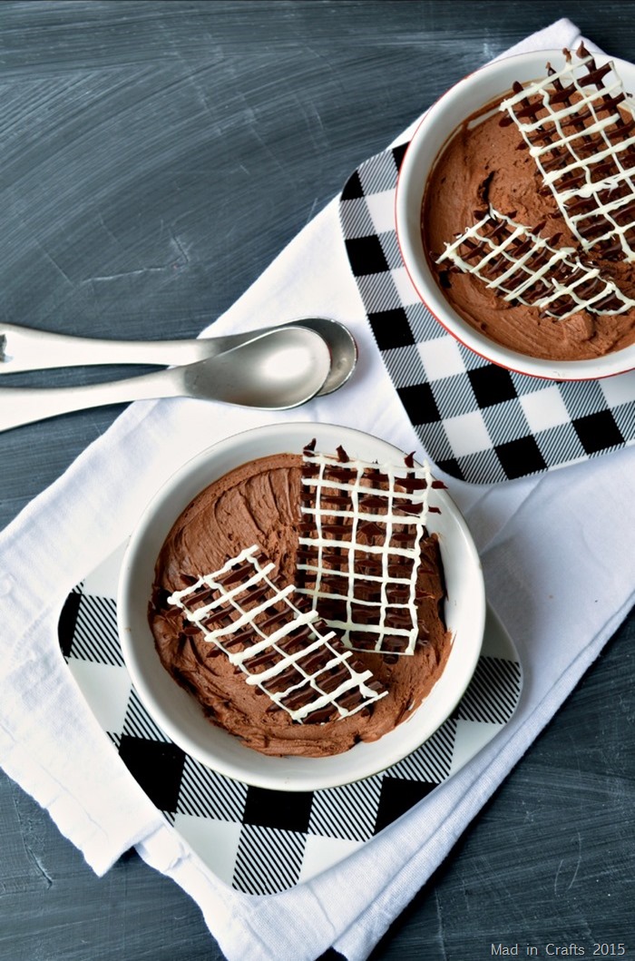 bowls of chocolate mousse with piped chocolate garnishes