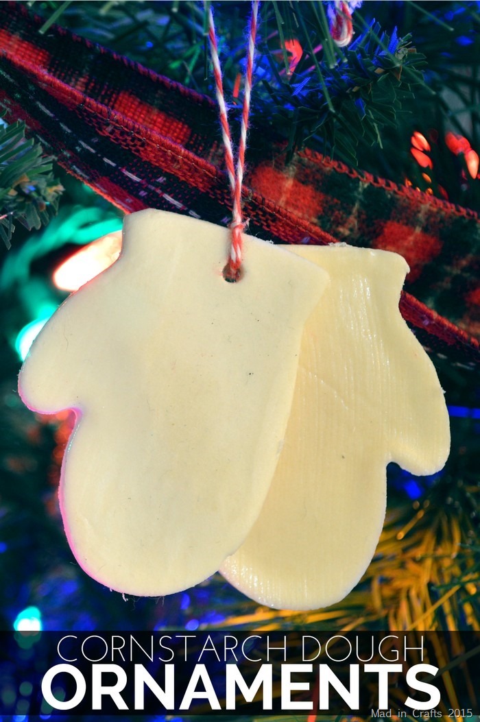 Pair of DIY clay mitten ornaments on a tree