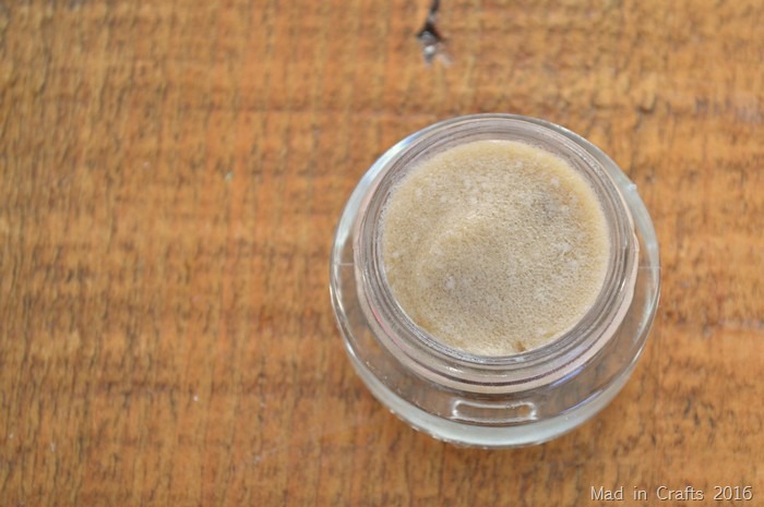 top view of small glass container of Coconut Oil, Honey & Brown Sugar Lip Scrub