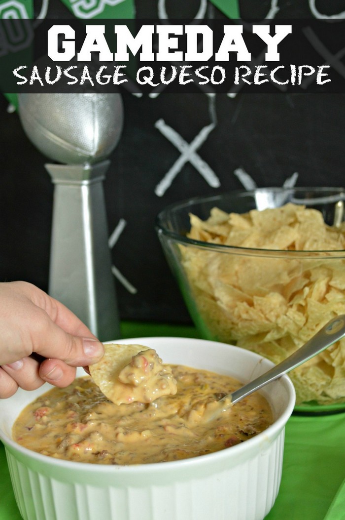 hand holding chip with queso, bowl of chips
