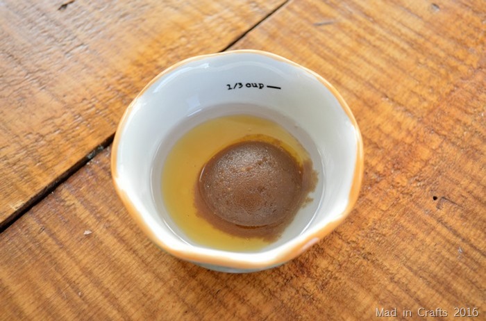 brown sugar, honey, and melted coconut oil in small bowl on a wood table