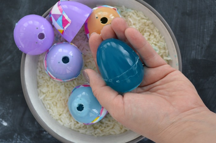 hand holding a blue egg soap fully removed from the plastic egg mold