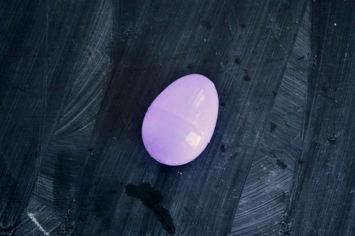 lavender plastic easter egg on a chalkboard background