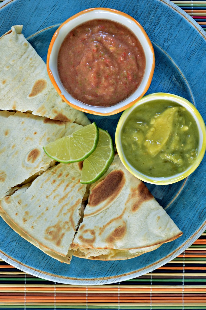 Blue plate of Quesadillas with bowls of Tangy Salsa and guacamole