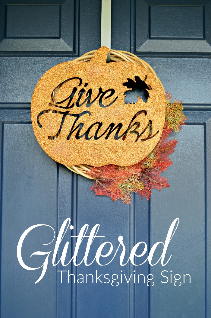 glittery Give Thanks sign wreath on a blue door