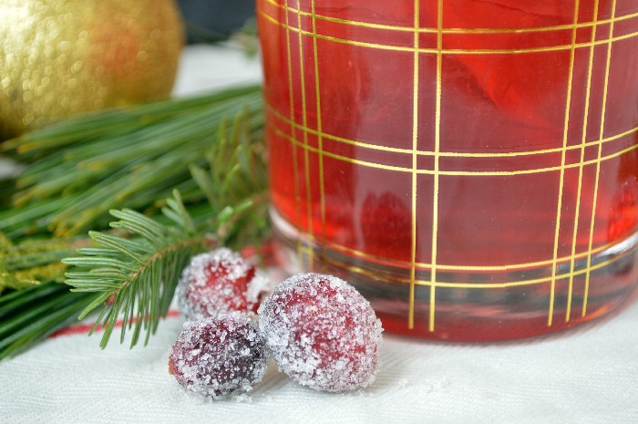 sugared cranberries next to cranberry cocktails