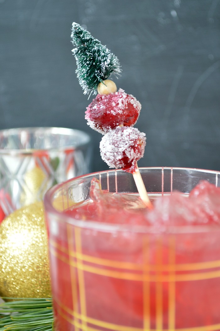 Cranberry cocktail with sugared cranberries on a cocktail pick