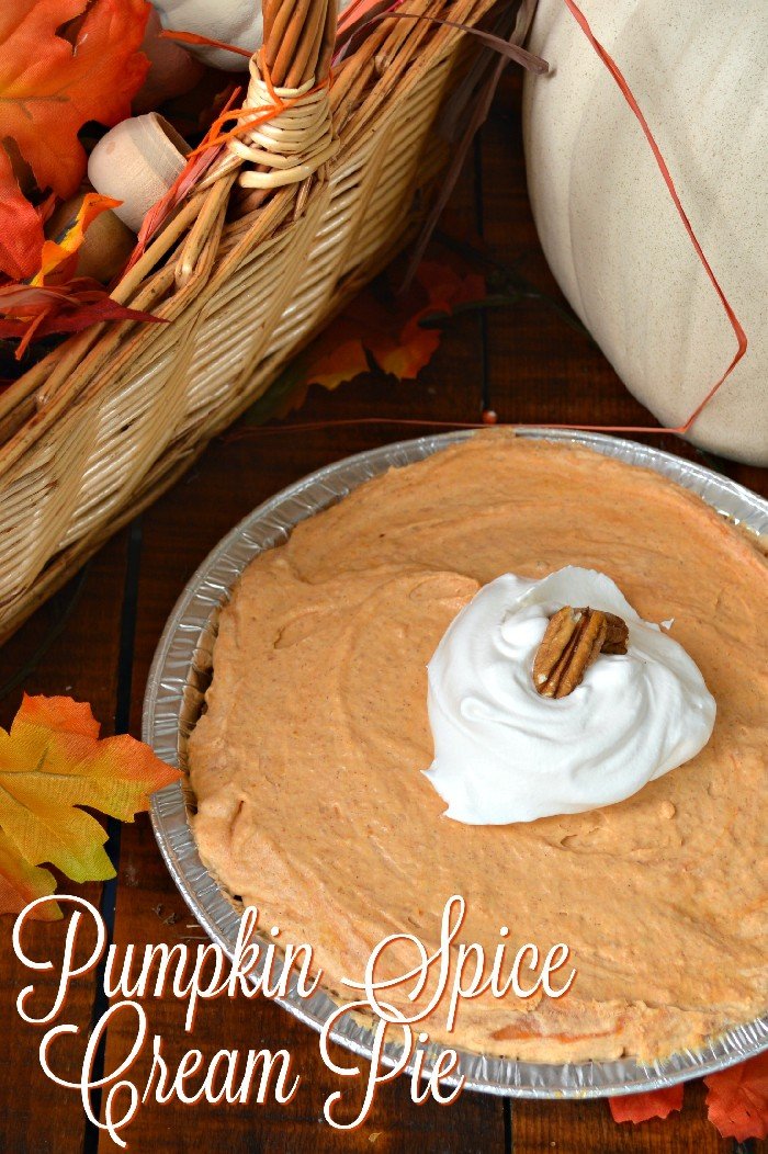 pumpkin cream pie next to fall leaves and a pumpkin