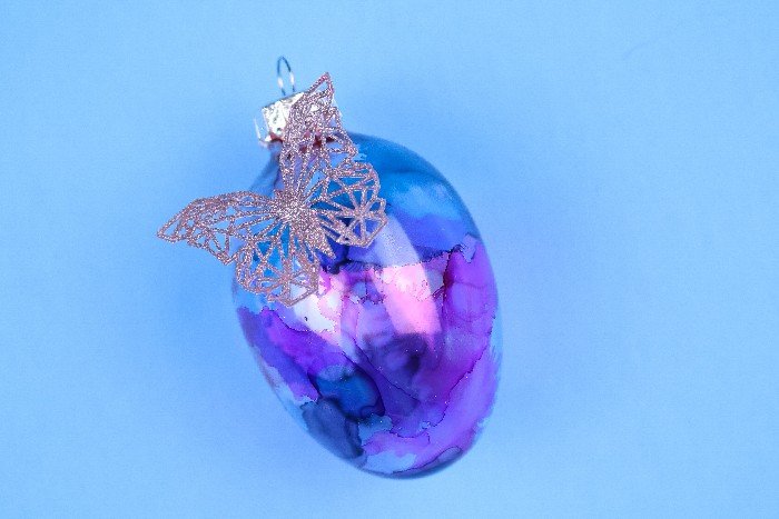 lilac geometric butterfly embellishment on an alcohol ink dyed glass egg ornament