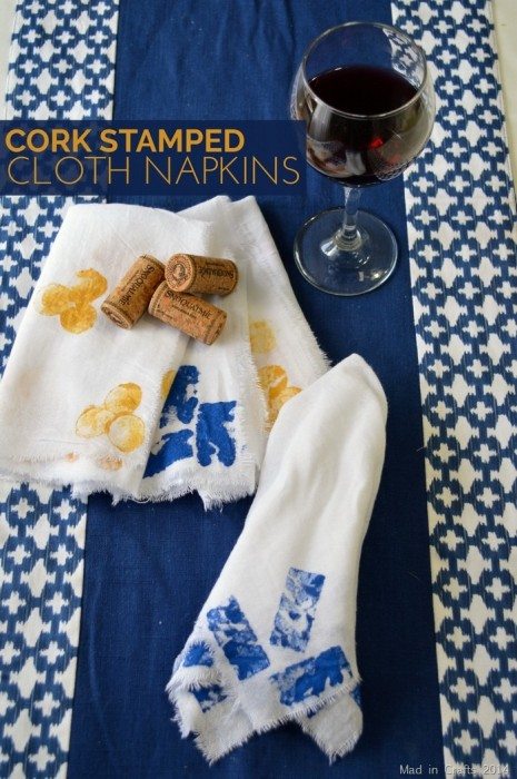 stamped cloth napkins, wine corks, and a blue background