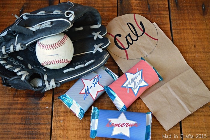 Decorated brown paper bag, baseball snacks, and a ball and glove