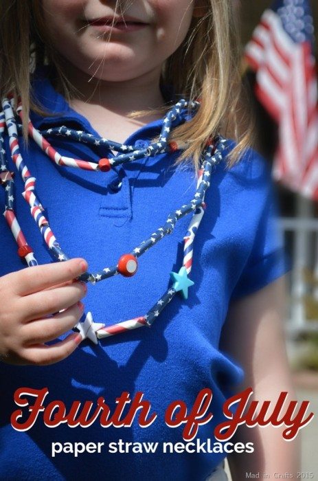 girl in blue shirt wearing necklaces made of paper straws