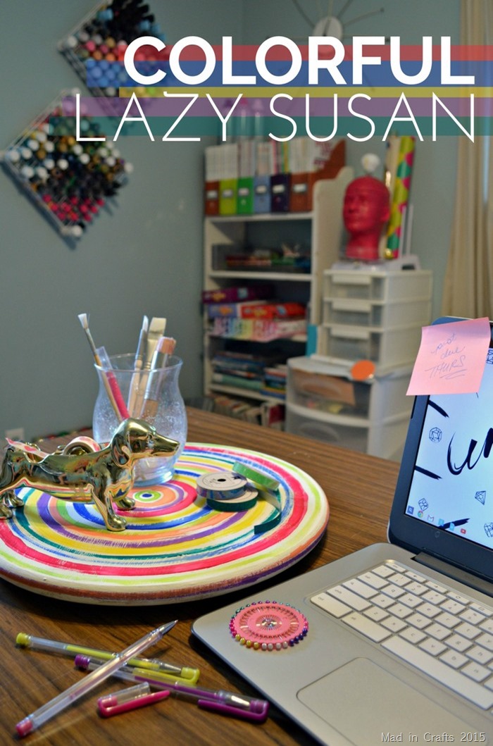 A laptop computer sitting on top of a table with a colorful painted lazy susan