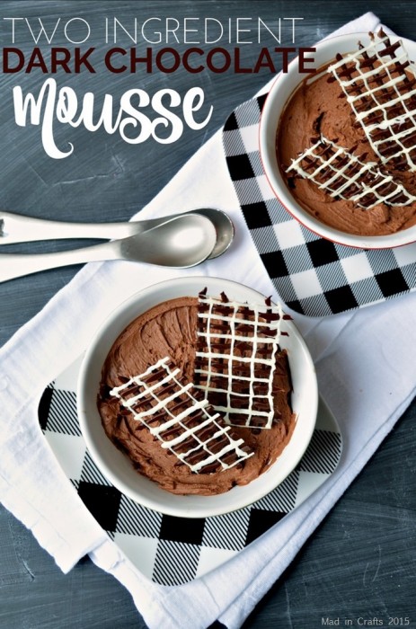 two bowls of chocolate mousse with piped chocolate garnish