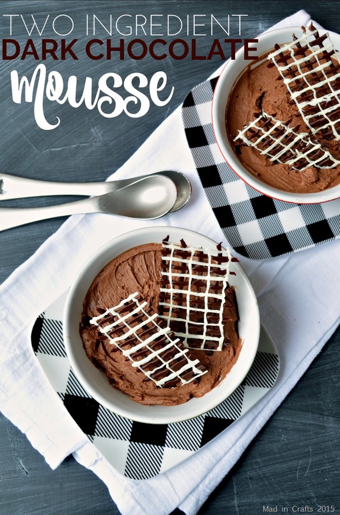 two bowls of chocolate mousse with piped chocolate garnish