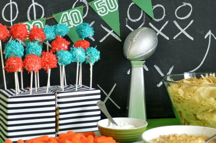 Super bowl party table with food and Lombardi Trophy centerpiece