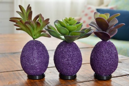 3 purple foam eggs topped with faux succulents