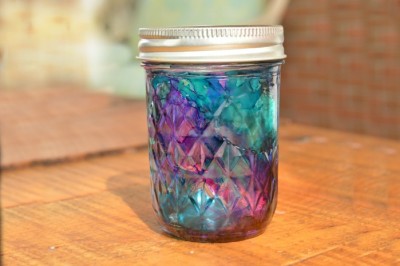 alcohol ink dyed mason jar on a wood table