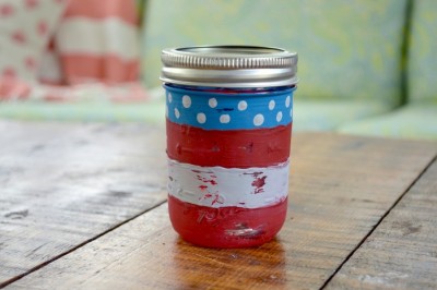 flag painted mason jar on a wood table