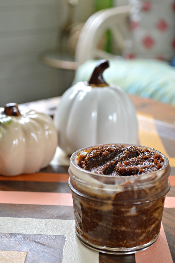 Close up of pumpkin spice latte sugar scrub on a table with a ceramic pumpkin