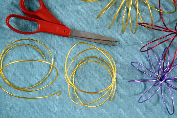colorful wire and scissors on a blue background