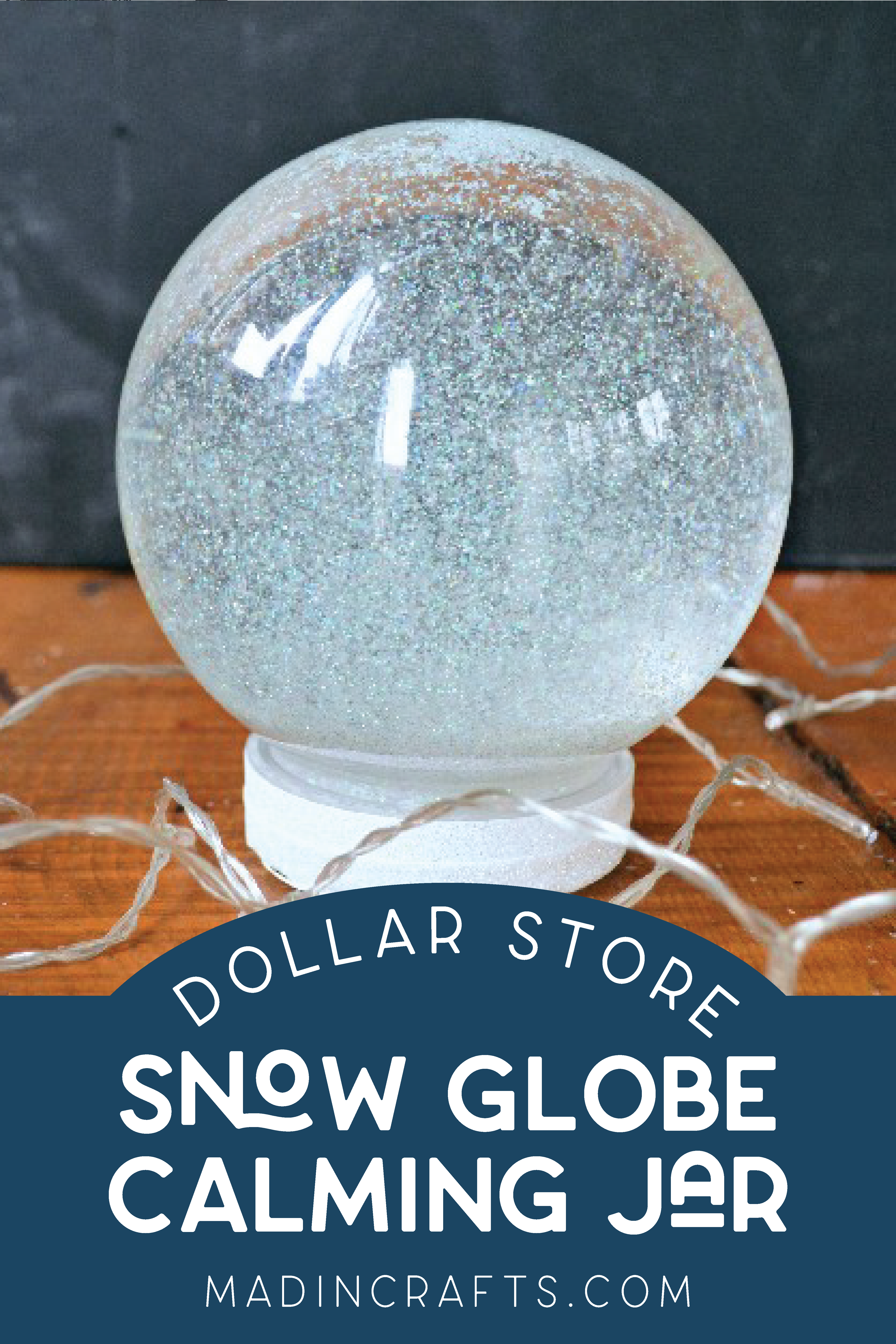 plastic snow globe filled with glitter and surrounded by white lights