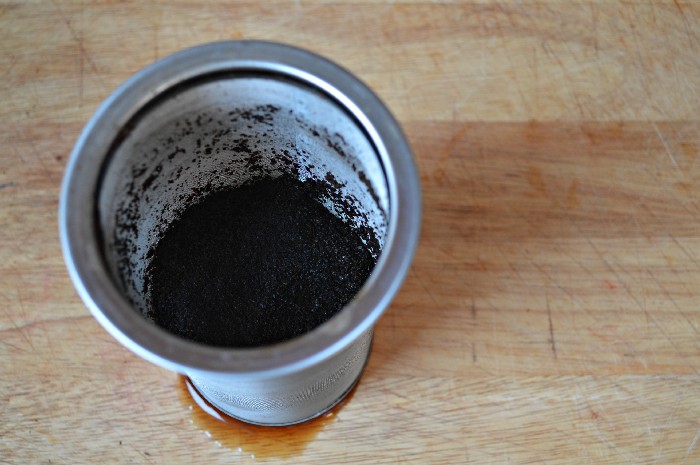 jar strainer full of used coffee grounds