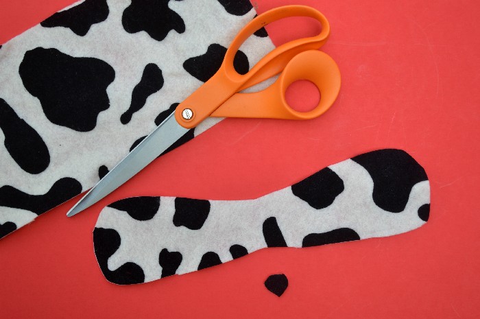 spotted felt and scissors on a red background