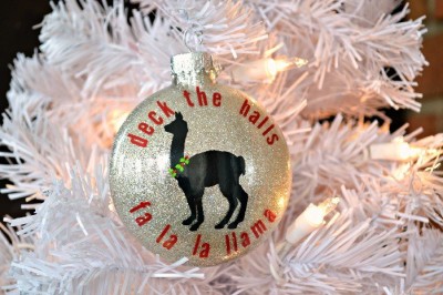 glitter ornament with fa la la llama vinyl design on a white tree