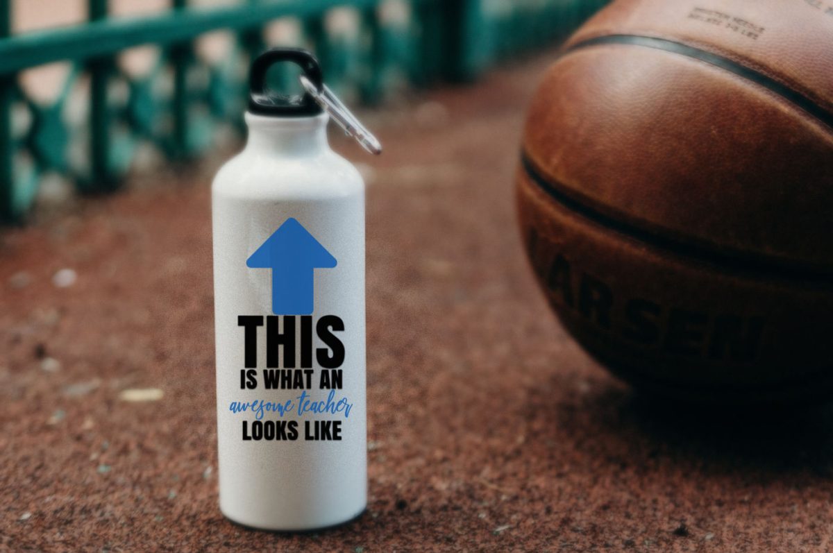 White water bottle with a This is What An Awesome Teacher Looks Like design. The bottle is sitting on the ground near a basketball.
