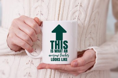 woman holding awesome teacher mug