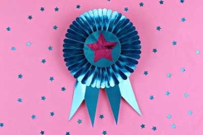 Cricut cut Blue foil ribbon on a pink background with blue foil stars
