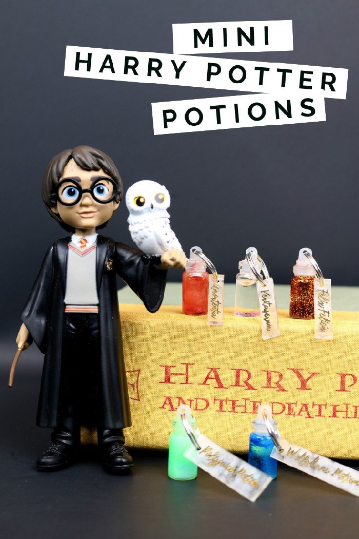 Mini Harry Potter Potion Charms on a copy of Deathly Hallows near a Harry Potter Toy