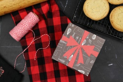 Cricut cut paper gift box with plaid towel and baker's twine