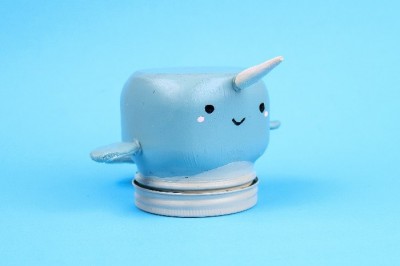 narwhal painted mason jar on a blue background