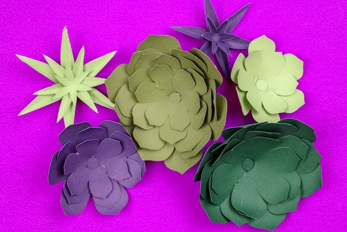 green and purple paper succulents on a purple background