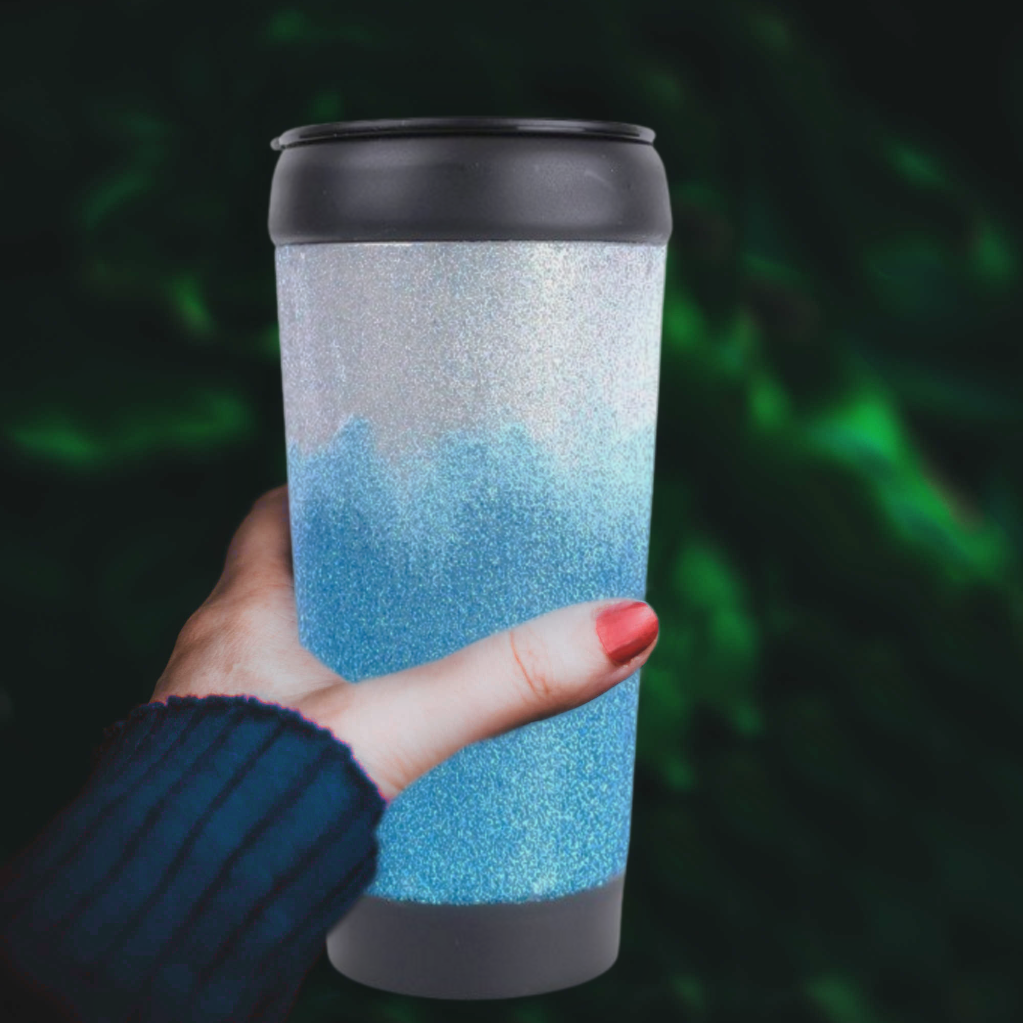 woman's hand holding a two toned glitter tumbler