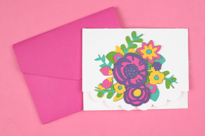 Cricut cut layered flowers on a card with a pink envelope