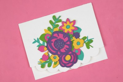 layered paper flower card on a pink background